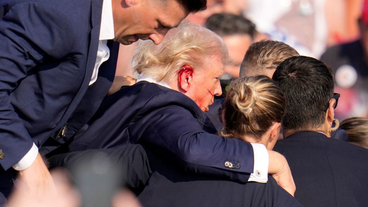 Republican presidential candidate former President Donald Trump is helped off the stage at a campaign event in Butler, Pa., on Saturday, July 13, 2024. (AP Photo/Gene J. Puskar)